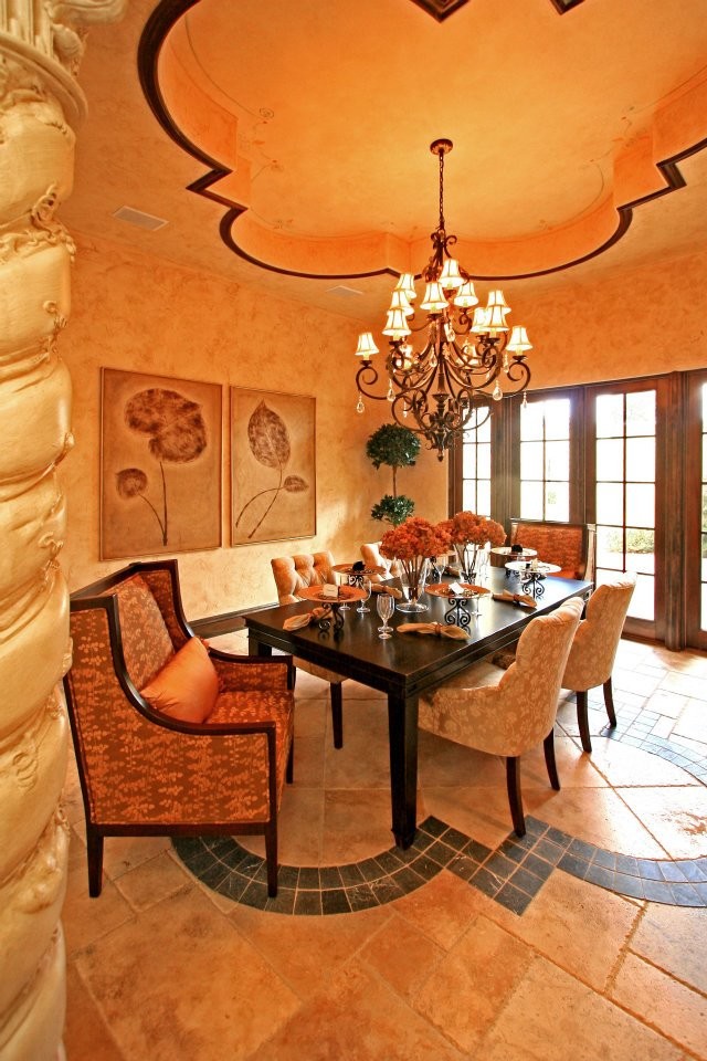 Inspiration for a large mediterranean separate dining room in Orlando with beige walls, travertine floors, no fireplace and beige floor.