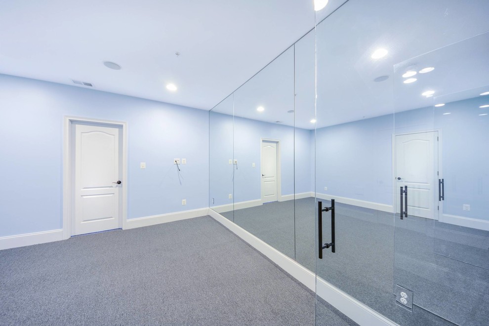 Medium sized traditional multi-use home gym in DC Metro with blue walls, carpet and black floors.