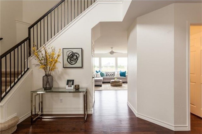 Foyer - large transitional dark wood floor foyer idea in Austin with white walls