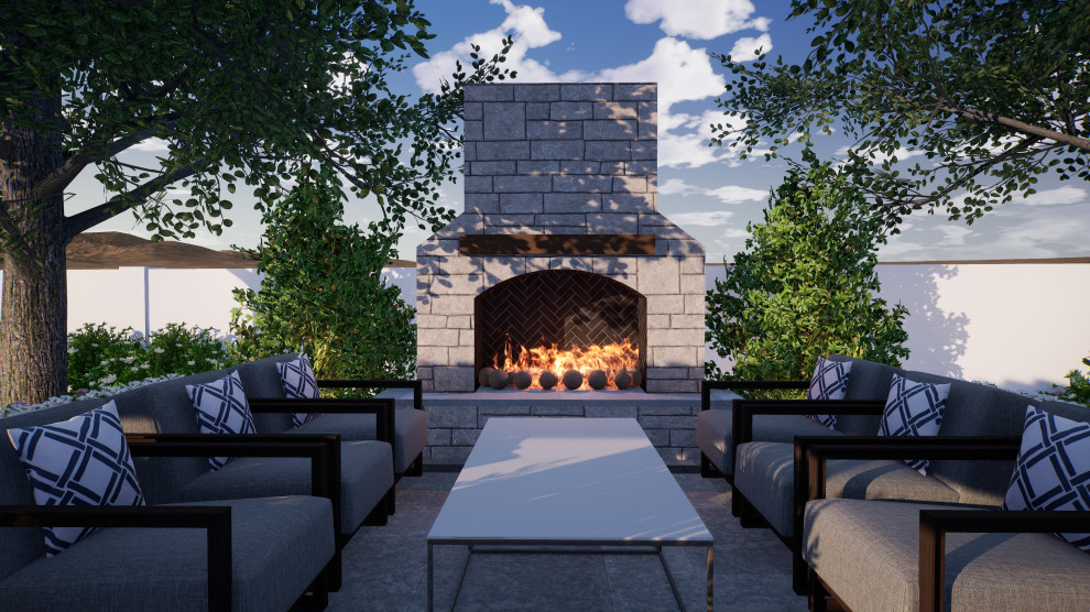 This is an example of a classic back patio in Phoenix with a fireplace and natural stone paving.