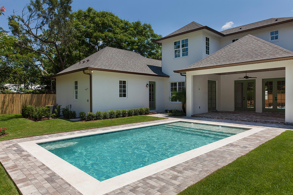 Large transitional backyard brick and rectangular pool fountain photo in Orlando