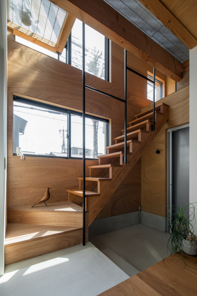 This is an example of a small asian wood straight staircase in Kyoto with wood risers, metal railing and wood walls.