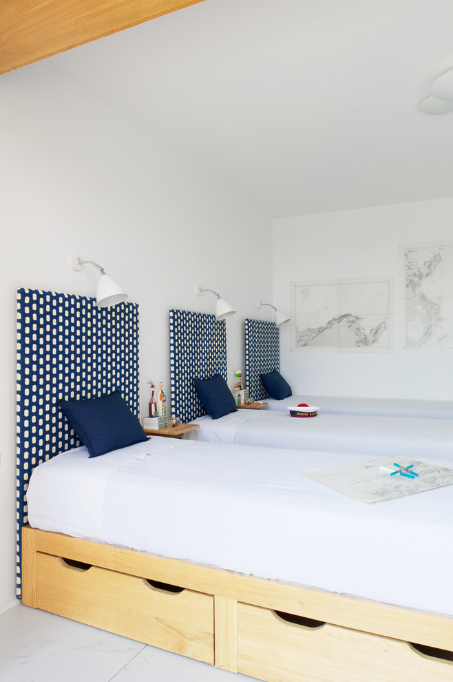 This is an example of a large contemporary gender-neutral kids' bedroom for kids 4-10 years old in Lyon with white walls and ceramic floors.