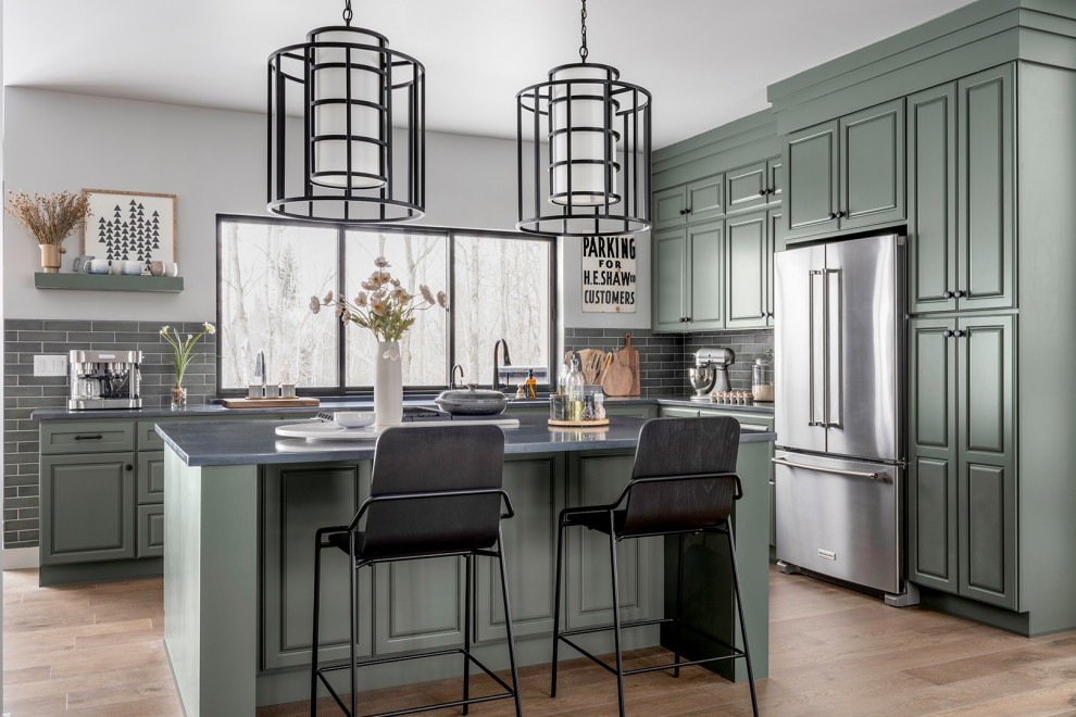 Eat-in kitchen - transitional medium tone wood floor and brown floor eat-in kitchen idea in Other with an undermount sink, raised-panel cabinets, green cabinets, quartz countertops, gray backsplash, subway tile backsplash, stainless steel appliances, an island and gray countertops