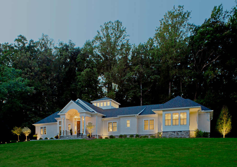 Large traditional one-storey white house exterior in Baltimore with concrete fiberboard siding and a shingle roof.