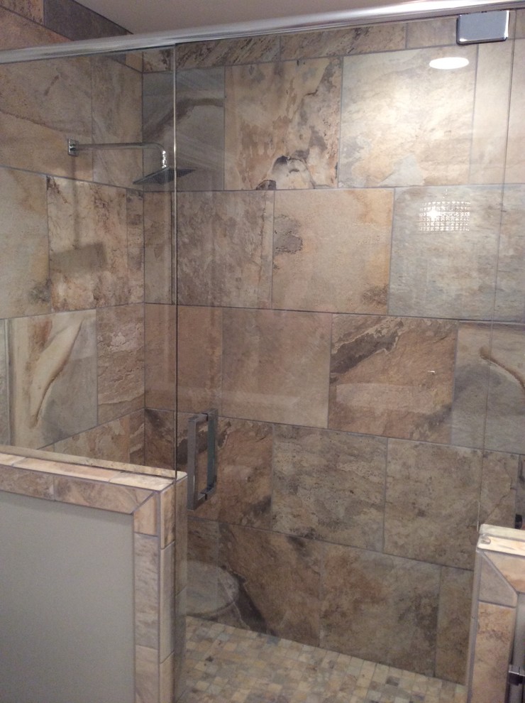Inspiration for a mid-sized transitional master beige tile and ceramic tile ceramic tile freestanding bathtub remodel in Birmingham with an undermount sink, flat-panel cabinets, dark wood cabinets, marble countertops, a two-piece toilet and beige walls