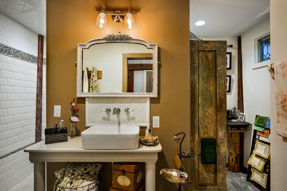 This is an example of a country bathroom in Boston with a vessel sink, white tile, subway tile and white walls.