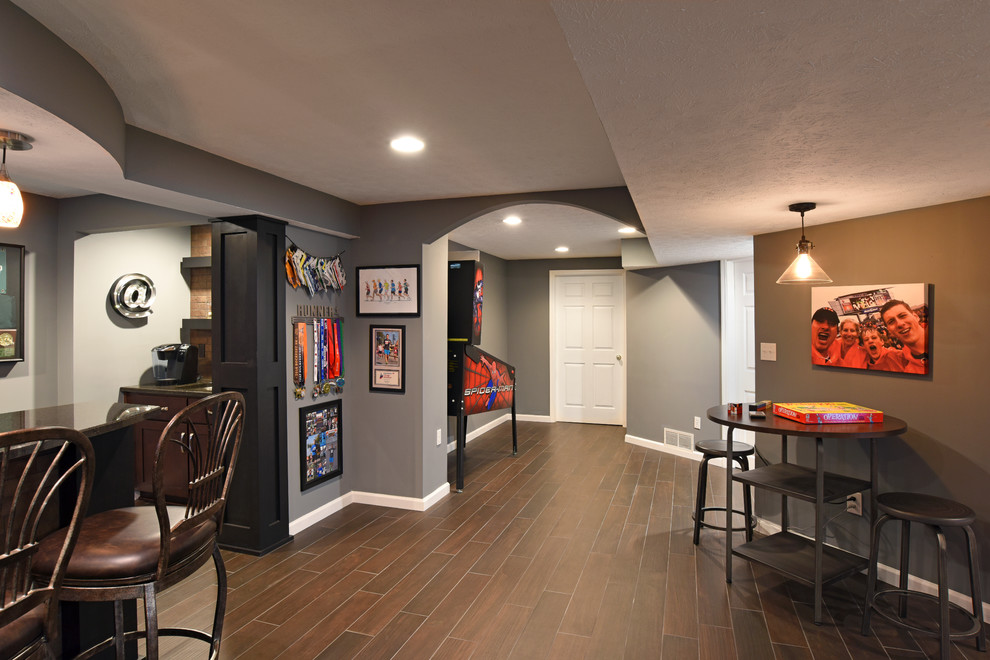 Inspiration for a large transitional galley porcelain tile and brown floor home design remodel with an undermount sink, shaker cabinets, dark wood cabinets, granite countertops, red backsplash and brick backsplash