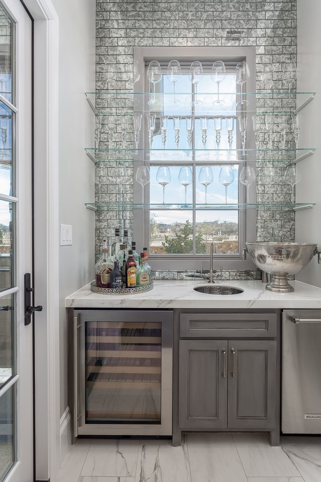 Photo of a traditional single-wall wet bar in Dallas with an undermount sink, recessed-panel cabinets, grey cabinets, white floor and white benchtop.
