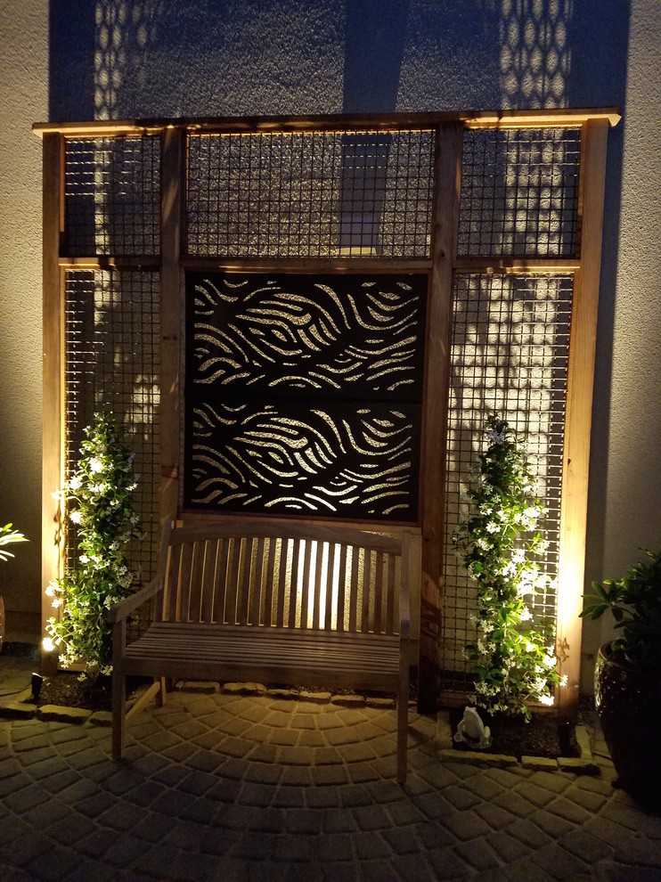 Design ideas for a small transitional courtyard concrete paver formal garden.