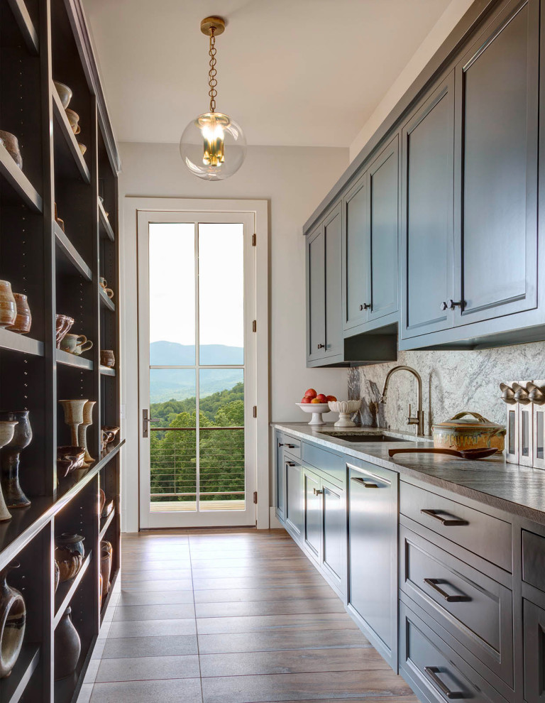 Example of a huge transitional galley porcelain tile and brown floor kitchen pantry design in Richmond with a drop-in sink, beaded inset cabinets, blue cabinets, quartz countertops, gray backsplash, quartz backsplash, paneled appliances and gray countertops