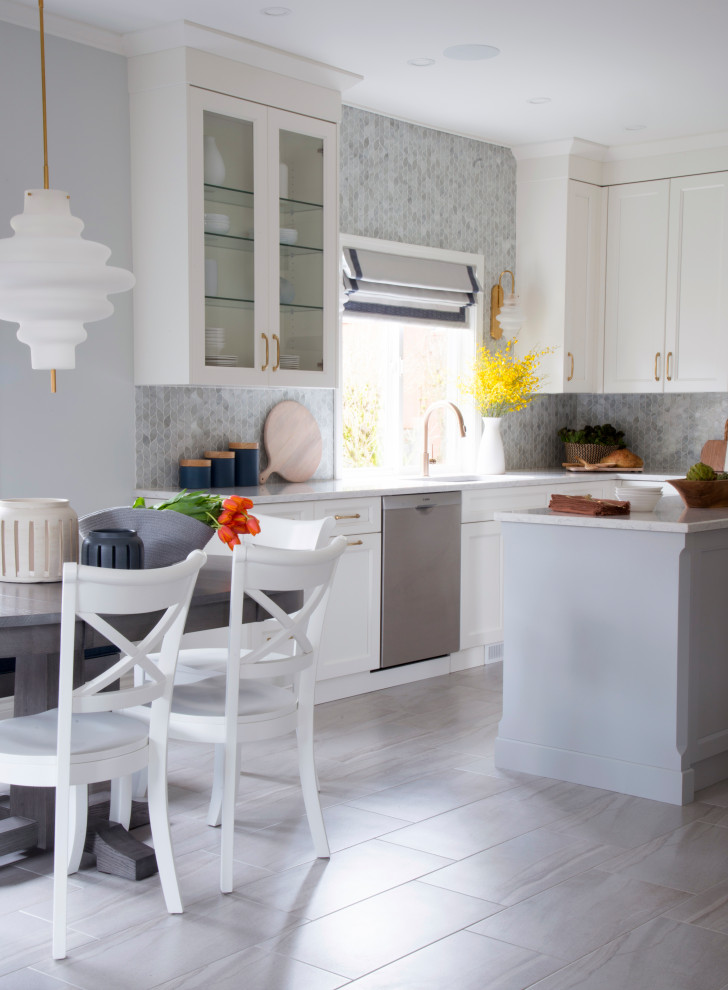 Kitchen - large transitional u-shaped porcelain tile and gray floor kitchen idea in Vancouver with an undermount sink, shaker cabinets, white cabinets, quartz countertops, white backsplash, glass tile backsplash, stainless steel appliances, an island and white countertops