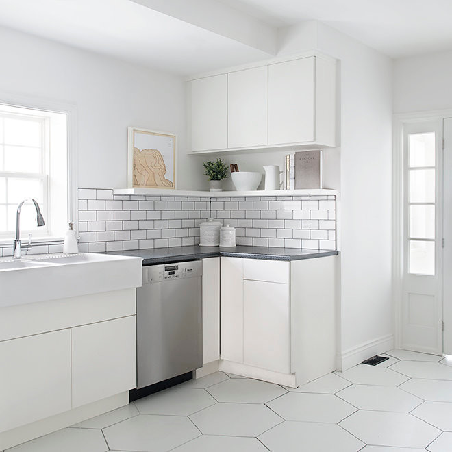 Design ideas for a large contemporary l-shaped eat-in kitchen in Other with a farmhouse sink, laminate benchtops, white splashback, subway tile splashback, stainless steel appliances, ceramic floors and white floor.