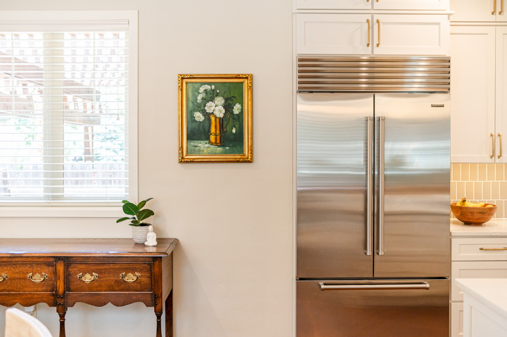 Large transitional l-shaped dark wood floor and brown floor open concept kitchen photo in Denver with a farmhouse sink, shaker cabinets, beige cabinets, quartz countertops, beige backsplash, ceramic backsplash, stainless steel appliances, an island and white countertops