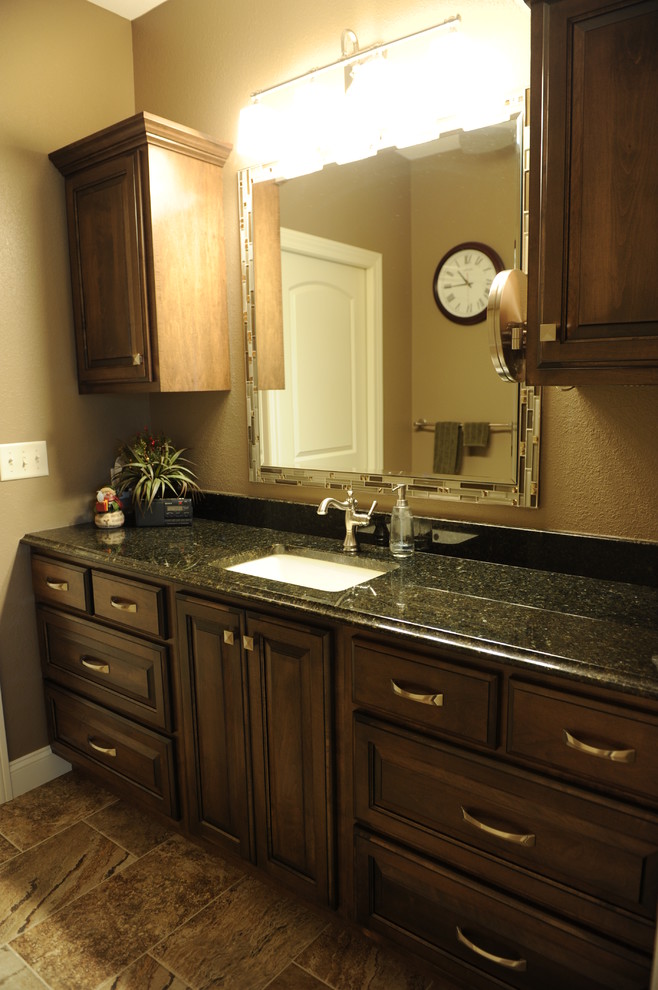 This is an example of a transitional bathroom in Chicago with an undermount sink, raised-panel cabinets, medium wood cabinets, granite benchtops, a double shower, beige tile and ceramic tile.