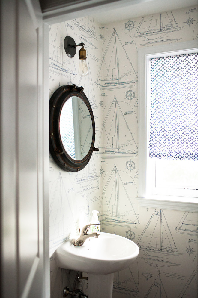 Small beach style powder room in Baltimore with a pedestal sink and multi-coloured walls.