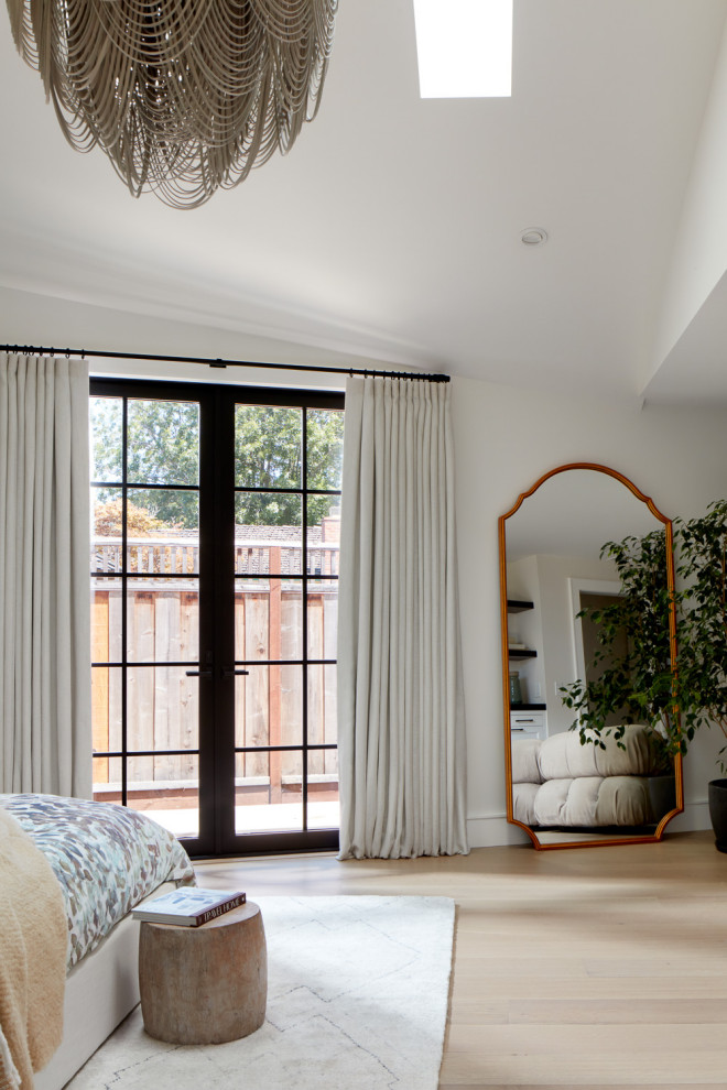 Inspiration for a large transitional master light wood floor and vaulted ceiling bedroom remodel in San Francisco
