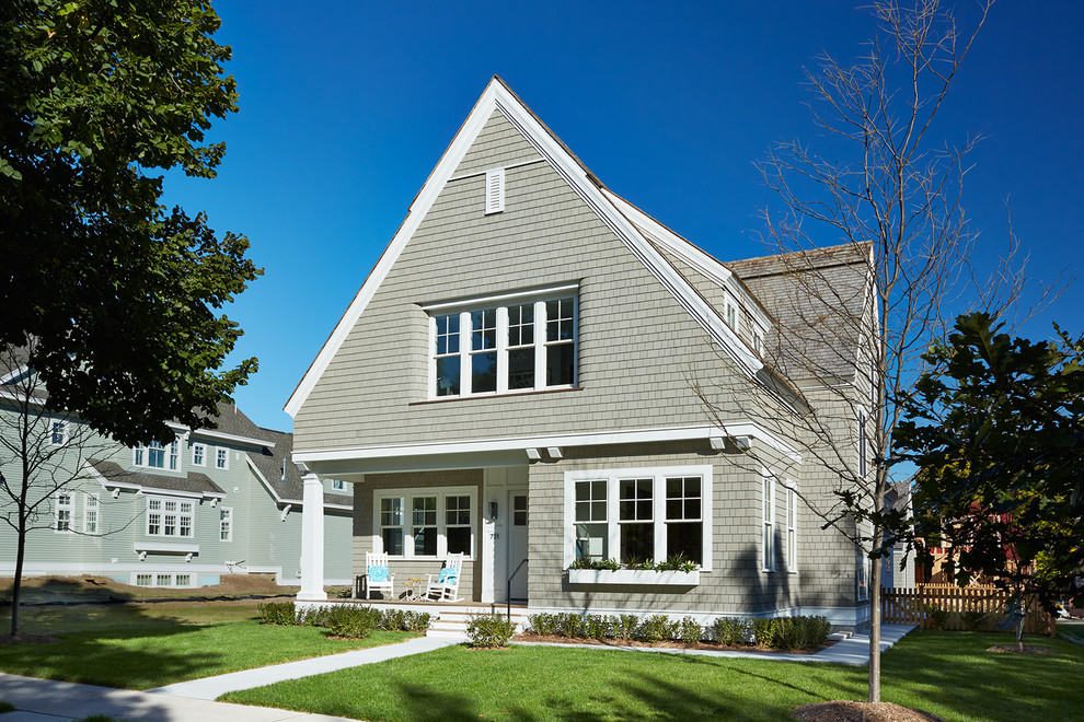 Photo of a transitional two-storey grey exterior in Minneapolis with wood siding and a gable roof.