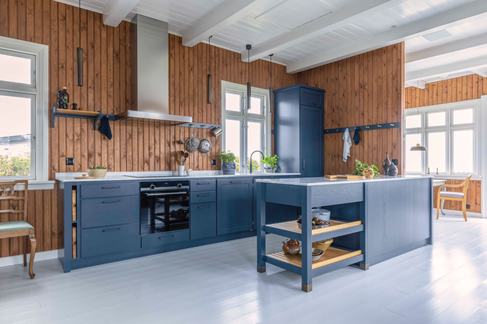 Inspiration for a large transitional galley kitchen in Copenhagen with an undermount sink, glass-front cabinets, blue cabinets, brown splashback, timber splashback, panelled appliances, a peninsula, grey floor, grey benchtop and wood.