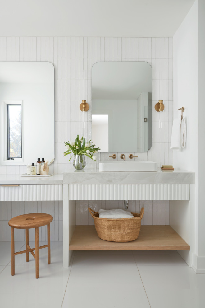 This is an example of a medium sized contemporary shower room bathroom in Toronto with flat-panel cabinets, white cabinets, white tiles, white walls, porcelain flooring, white floors, grey worktops, a single sink and a floating vanity unit.
