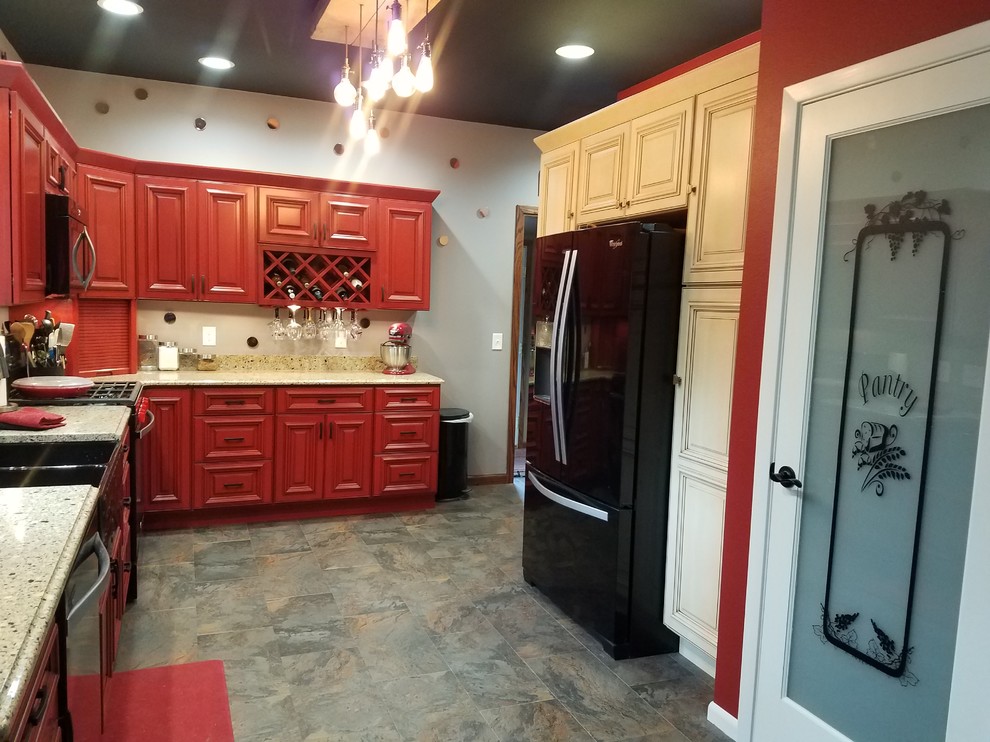 Kitchen pantry - l-shaped slate floor and multicolored floor kitchen pantry idea in Cedar Rapids with a double-bowl sink, beaded inset cabinets, red cabinets, black appliances, no island and brown countertops