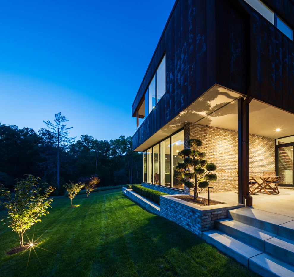 Ispirazione per un grande privacy in giardino minimalista dietro casa con pavimentazioni in cemento