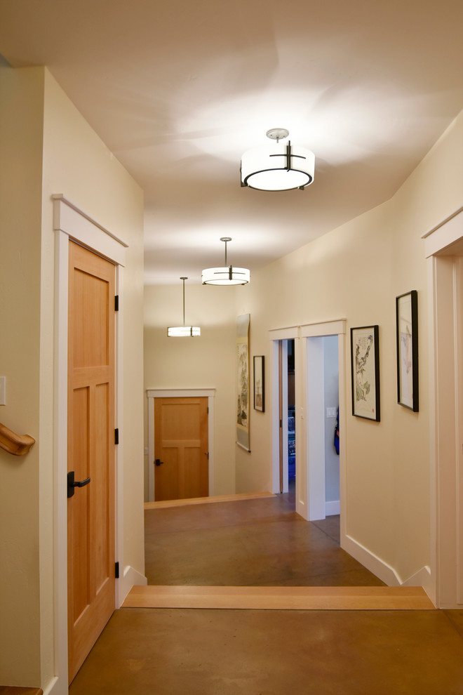 Design ideas for a large arts and crafts hallway in Albuquerque with yellow walls and concrete floors.
