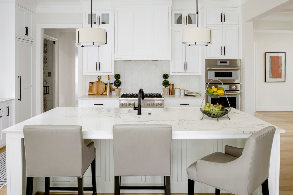Inspiration for a large transitional light wood floor, beige floor and coffered ceiling eat-in kitchen remodel in DC Metro with shaker cabinets, white cabinets, marble countertops, white backsplash, an island and multicolored countertops