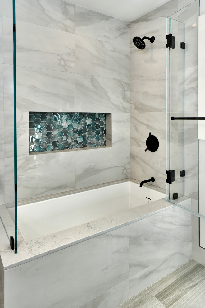 Inspiration for a mid-sized modern 3/4 bathroom in San Francisco with grey cabinets, a drop-in tub, a shower/bathtub combo, a one-piece toilet, gray tile, porcelain tile, grey walls, porcelain floors, an undermount sink, engineered quartz benchtops, grey floor, a hinged shower door and grey benchtops.