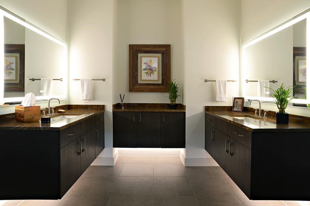Photo of a modern bathroom in Dallas with flat-panel cabinets, brown cabinets, white walls, ceramic floors, an undermount sink, onyx benchtops, brown floor and brown benchtops.
