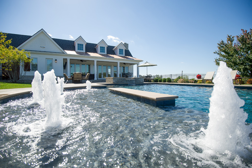 Large transitional backyard concrete and rectangular pool house photo