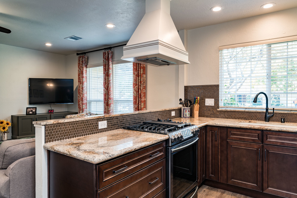 Mid-sized transitional u-shaped medium tone wood floor and brown floor eat-in kitchen photo with an undermount sink, recessed-panel cabinets, white cabinets, granite countertops, brown backsplash, mosaic tile backsplash, stainless steel appliances and no island