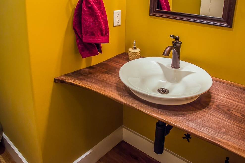 Bathroom - mid-sized transitional 3/4 bathroom idea with yellow walls, a vessel sink, wood countertops and brown countertops