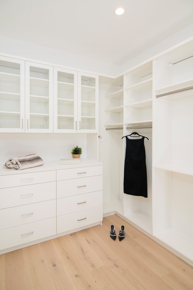 This is an example of a contemporary storage and wardrobe in San Francisco with flat-panel cabinets and white cabinets.
