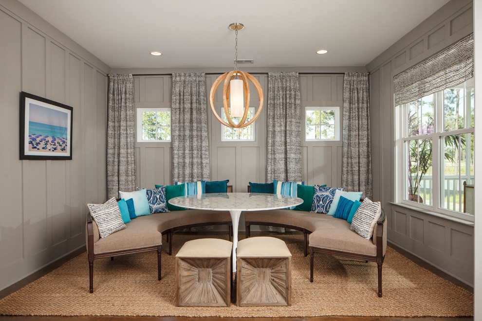 This is an example of a beach style dining room in Charleston with grey walls.