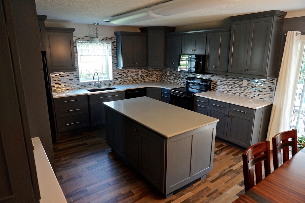 Transitional u-shaped linoleum floor eat-in kitchen photo with an undermount sink, shaker cabinets, gray cabinets, quartz countertops, gray backsplash, mosaic tile backsplash, black appliances and an island