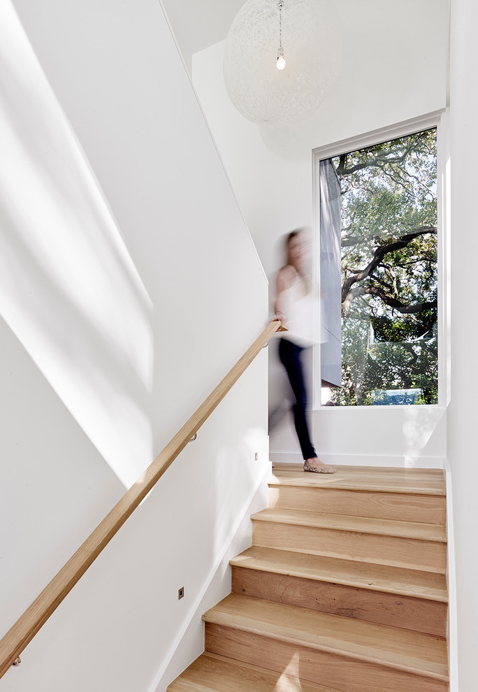 Photo of a mid-sized contemporary wood u-shaped staircase in Austin with wood risers.
