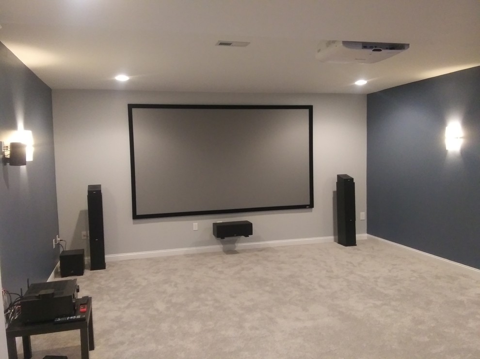 Photo of a mid-sized contemporary home theatre in Columbus with blue walls, carpet and beige floor.