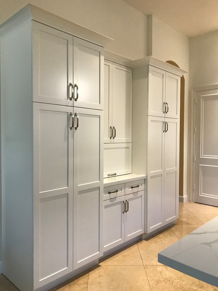 Large transitional kitchen photo in Miami with a farmhouse sink, shaker cabinets, white cabinets, quartz countertops, gray backsplash, glass tile backsplash, stainless steel appliances, an island and multicolored countertops