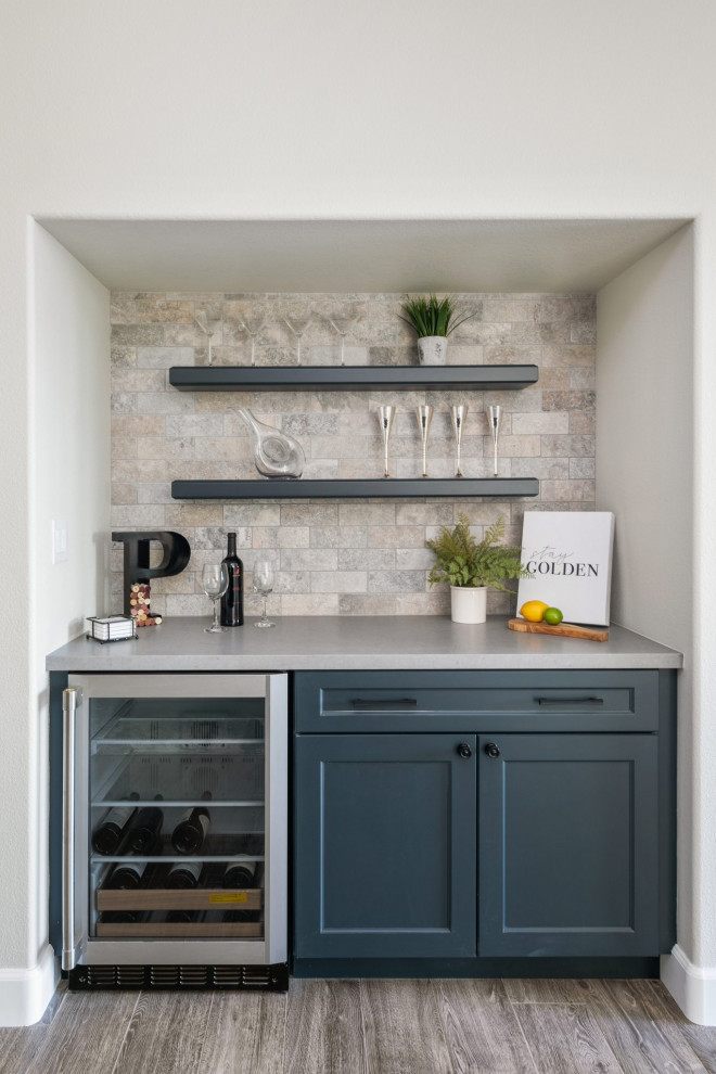 Wet bar - small transitional single-wall porcelain tile and multicolored floor wet bar idea in Orange County with no sink, floating shelves, blue cabinets, quartz countertops, beige backsplash and gray countertops