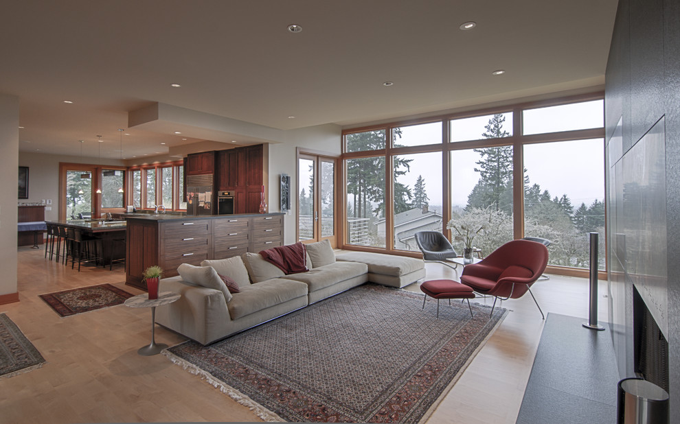 This is an example of a large modern open concept living room in Portland.