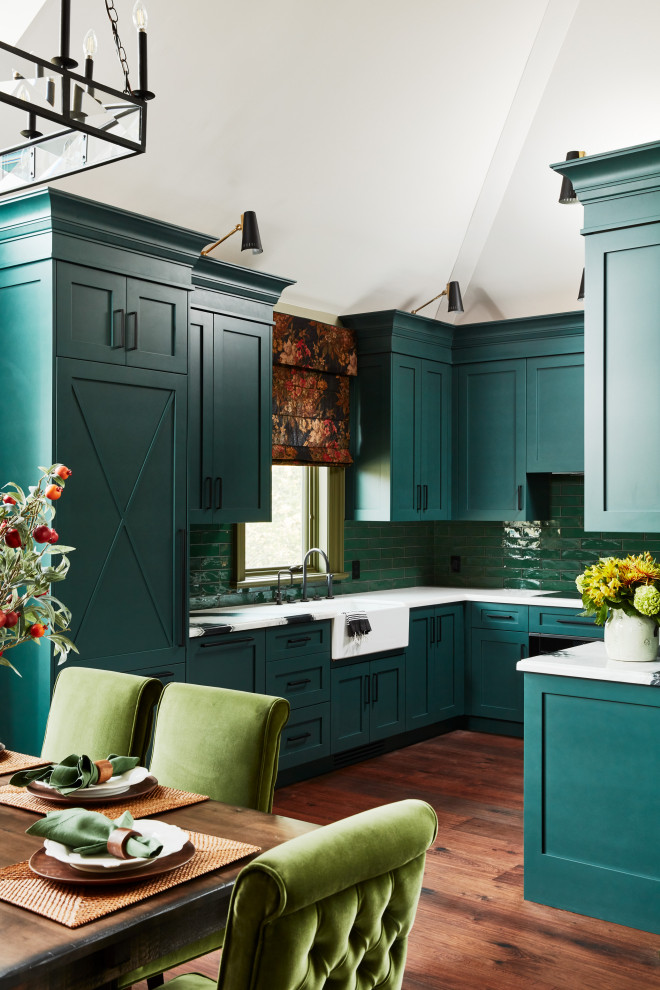 This is an example of a small country u-shaped eat-in kitchen in Toronto with a farmhouse sink, shaker cabinets, green splashback, no island, brown floor, white benchtop, vaulted, green cabinets, quartzite benchtops, porcelain splashback, stainless steel appliances and medium hardwood floors.