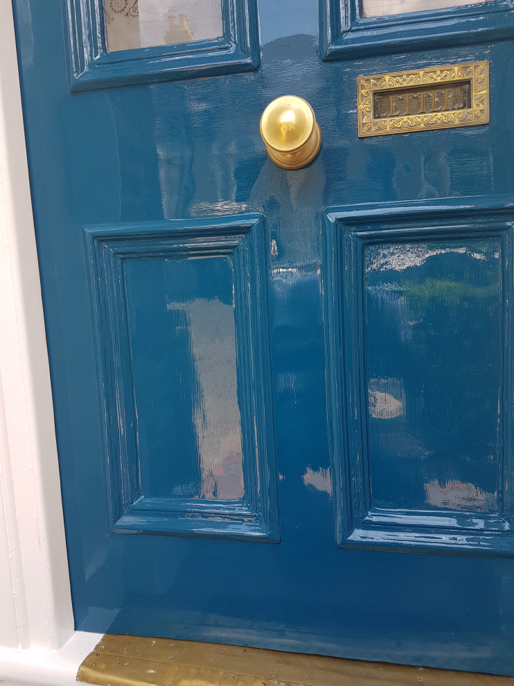 Inspiration for an expansive traditional front door in London with white walls, ceramic floors, a single front door, a blue front door, multi-coloured floor, recessed and brick walls.