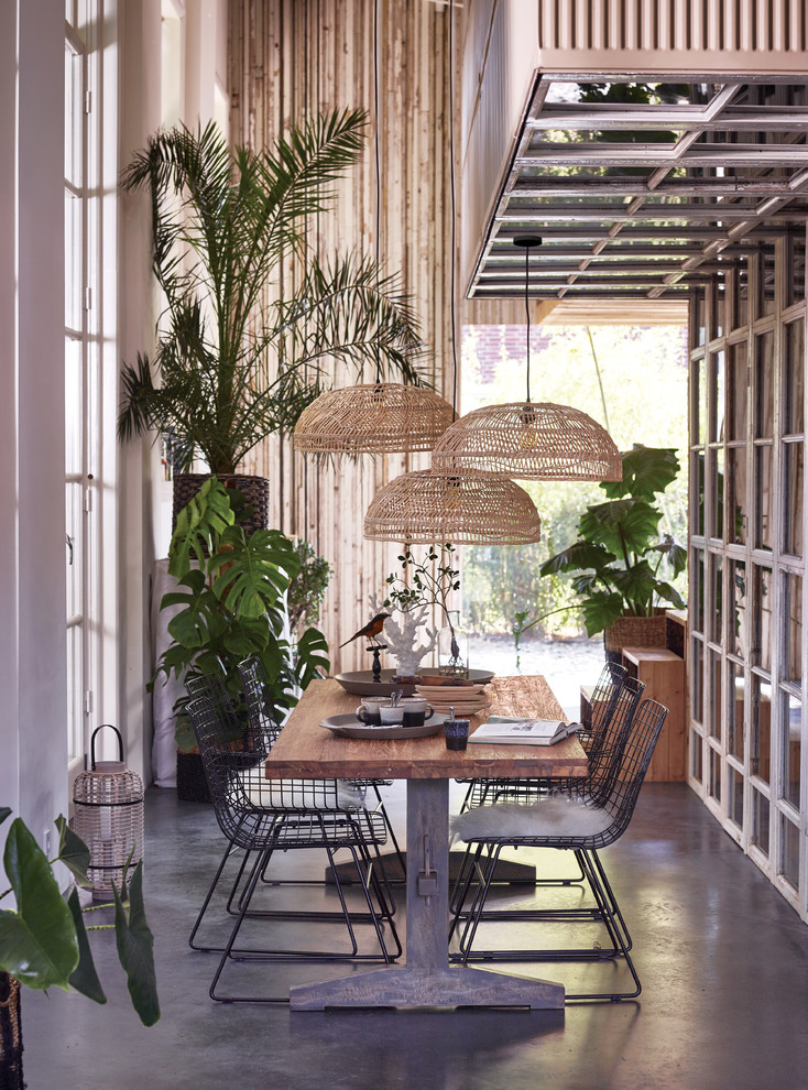 Design ideas for a large tropical dining room in Brisbane with concrete floors.