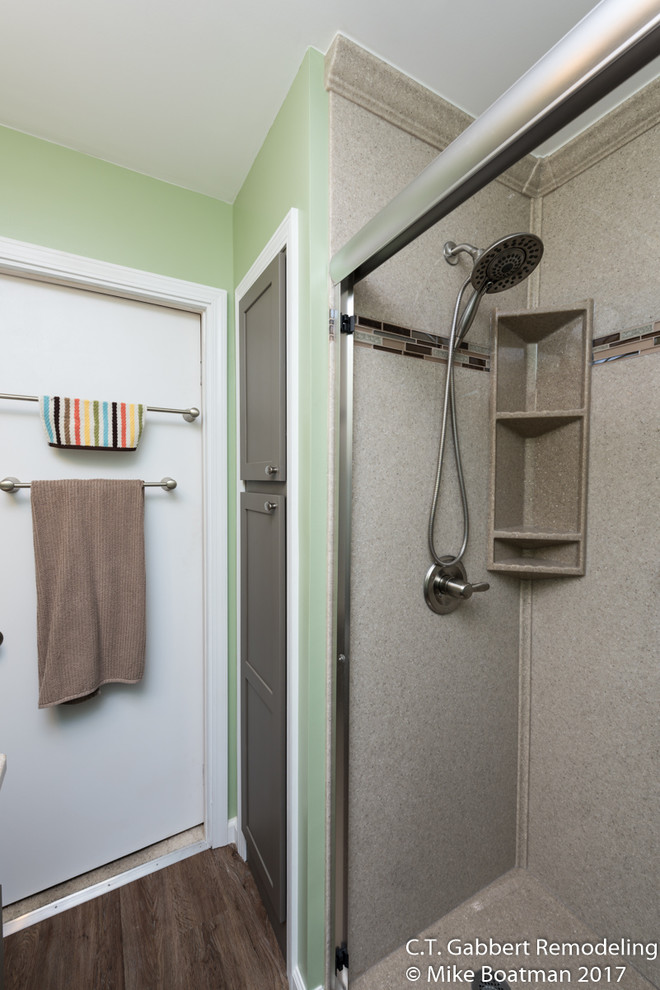 Inspiration for a small transitional 3/4 bathroom in Chicago with recessed-panel cabinets, grey cabinets, an alcove shower, multi-coloured walls, laminate floors, an integrated sink, onyx benchtops, brown floor and a sliding shower screen.
