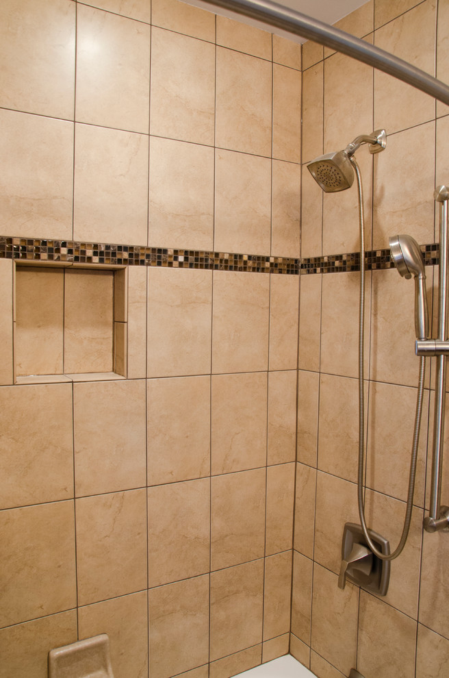 Inspiration for a mid-sized traditional master bathroom in DC Metro with a two-piece toilet, beige tile, brown tile, gray tile, multi-coloured tile, ceramic tile, shaker cabinets, medium wood cabinets, an alcove shower, beige walls, limestone floors, an undermount sink and marble benchtops.