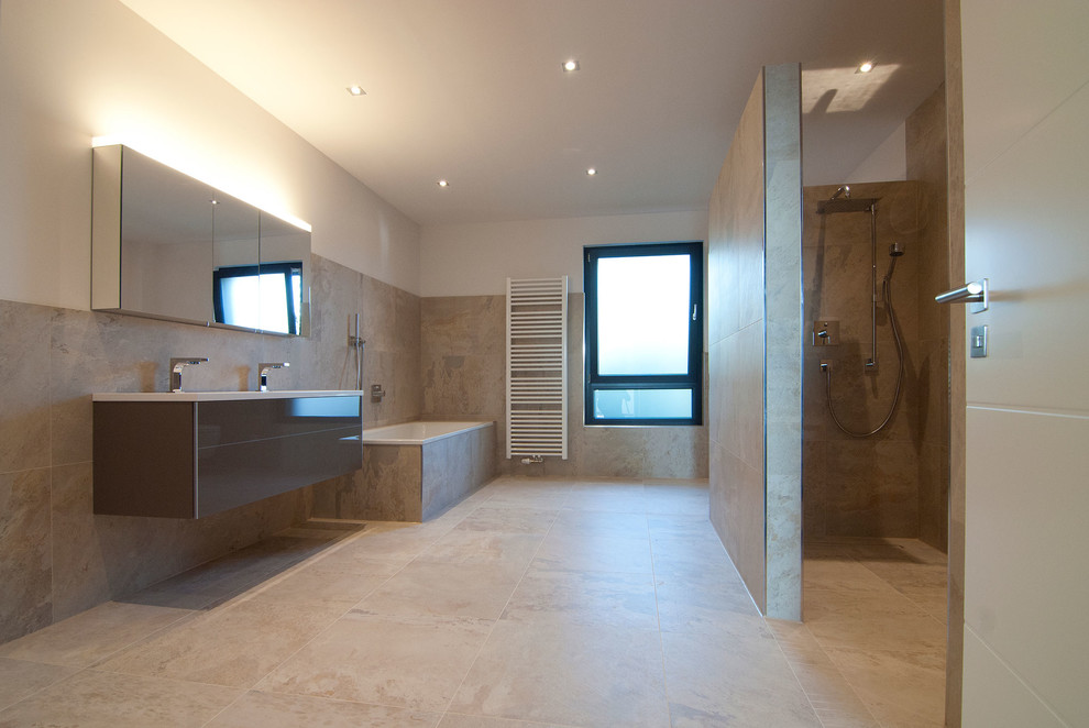 Inspiration for a large contemporary bathroom in Berlin with a drop-in tub, beige tile, ceramic tile, grey cabinets, an alcove shower, white walls, ceramic floors and a trough sink.