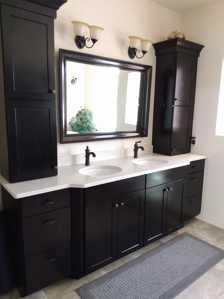 Photo of a large mediterranean master bathroom in Salt Lake City with shaker cabinets, dark wood cabinets, a claw-foot tub, a double shower, mirror tile, ceramic floors, an undermount sink, engineered quartz benchtops, a hinged shower door, white benchtops, a shower seat, a double vanity and a built-in vanity.