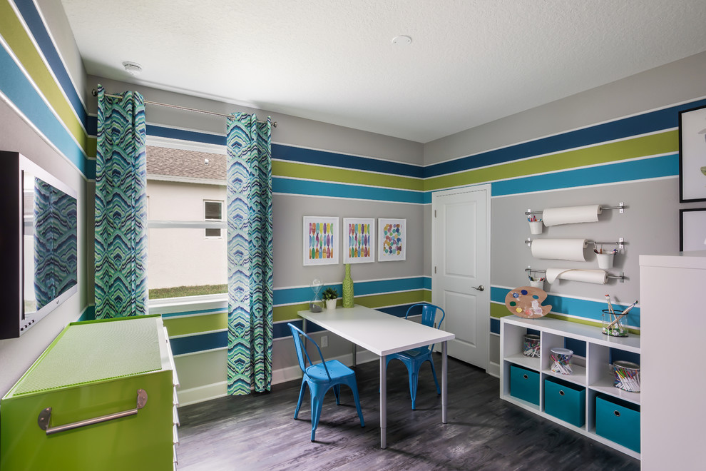 This is an example of a transitional gender-neutral kids' playroom in Jacksonville with multi-coloured walls and grey floor.