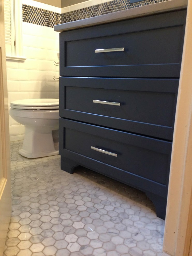 Small traditional bathroom in New York with an undermount sink, shaker cabinets, blue cabinets, engineered quartz benchtops, a two-piece toilet, white tile, subway tile, grey walls, marble floors, an alcove tub and a shower/bathtub combo.